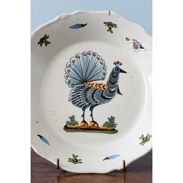 Diameter: 23 cm Height: 3.5 cm Slight wear throughout, commensurate with age. A glaze defect to the lip, otherwise very...