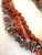 Stunning, four strand necklace featuring a collection of faceted carnelian beads, uniquely shaped freshwater pearls (each...