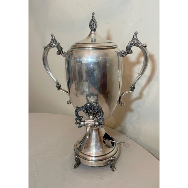 Up for sale is a wonderful antique silverplated tea samovar. It's done with ornate detailing and features two elaborate...
