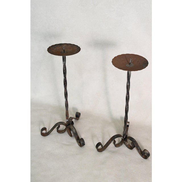Twisted iron stems, scrolled feet, and all the character that comes from being made by hand. These holders move easily...