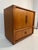 A stunning mid-century modern highboard/TV cabinet from Dyrlund, crafted from elegant teak. The sideboard features...