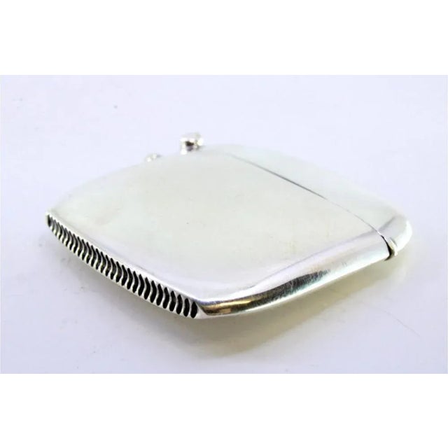 Plain Silver Matchbox with Beveled Corners and Hanging Ring, in Very Good conditions. Designed 1890 to 1919 This piece has...