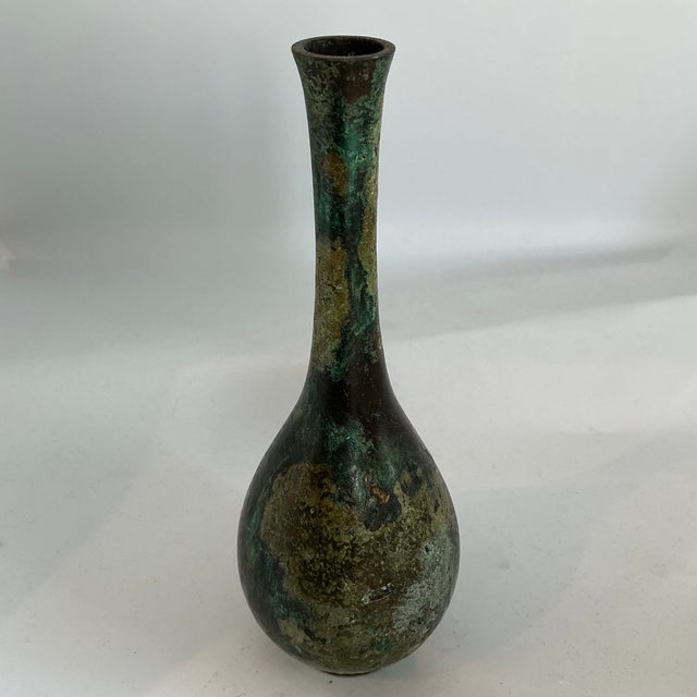 Classic Japanese bud vase with one of a kind aged bronze finish. Mottled finish created with chemicals & heat. All edges...