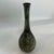 Classic Japanese bud vase with one of a kind aged bronze finish. Mottled finish created with chemicals & heat. All edges...