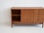 Sideboard made of teak wood with sliding doors and five drawers, brass details. Manufactured in Italy by La Permanente...