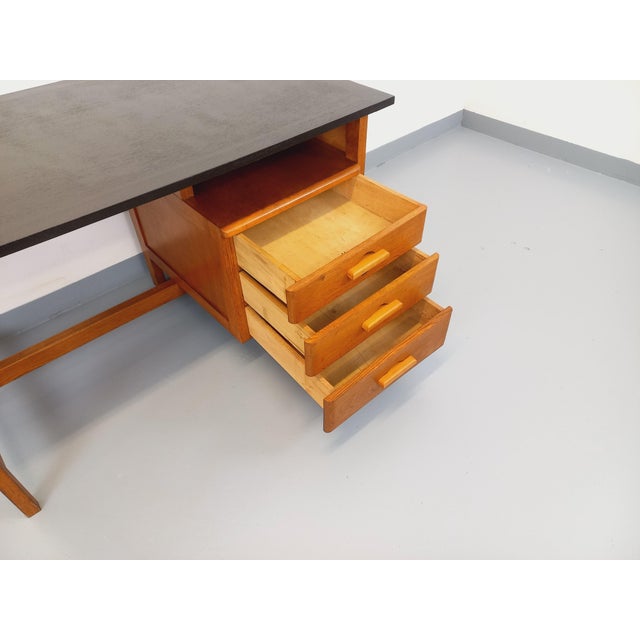 Vintage 1960s oak desk with a beautiful Brutalist design, featuring three drawers with original handles, a black wood top,...