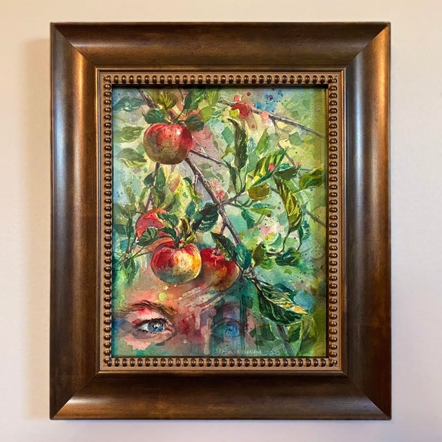 In "Every Secret Place," vibrant apples dangle from lush branches, their rich colors contrasting with the soft, ethereal...