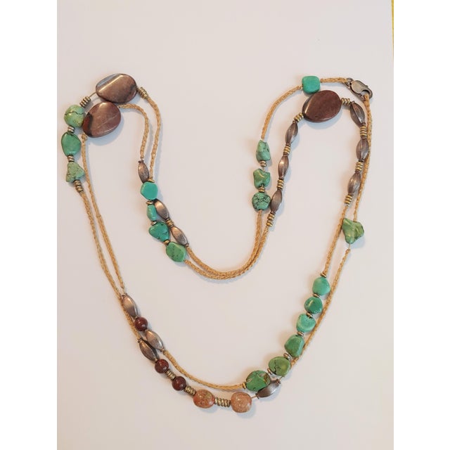 Here's a finely beaded necklace circa 1980s that features chunky turquoise and jasper beads with hand braided cord and...