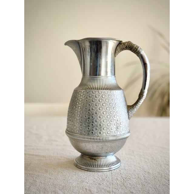 Antique silverplate pitcher by James Tufts, Boston, marked quadruple plate, featuring an allover embossed pattern with...