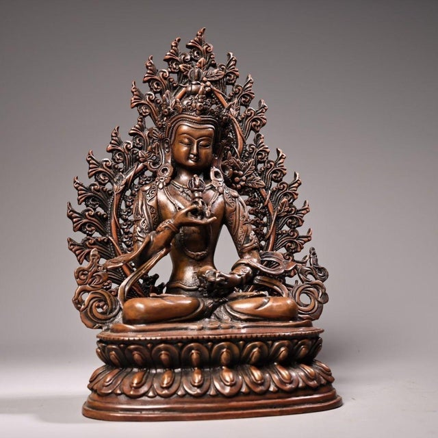 This is a finely crafted antique bronze sculpture of Vajrasattva, a revered figure in Tibetan Buddhism. The statue depicts...