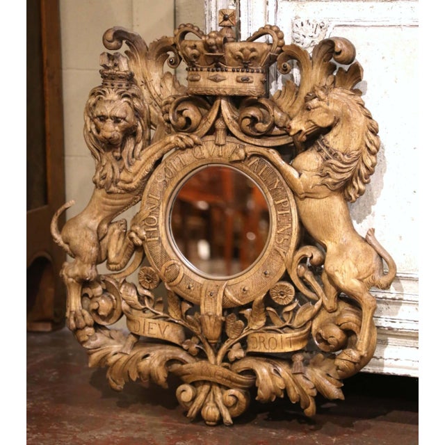 Boldly sculptural and richly detailed, this antique heraldic mirror is a striking example of Black Forest-style carving....