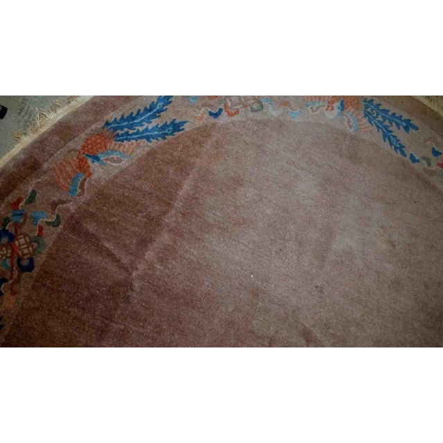 Handmade antique Art Deco Chinese rug in oval shape. The rug is from the beginning of 20th century in original condition,...