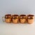 Charming set of four miniature copper Moscow Mule shot mugs. Brass handles. Light wear.