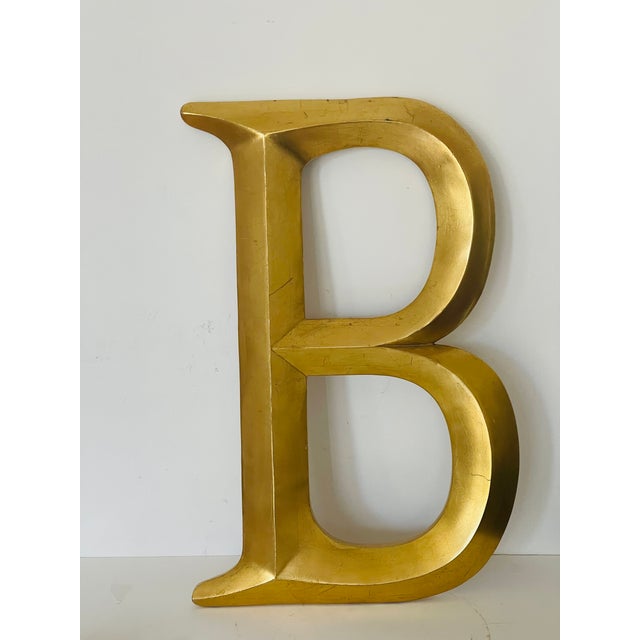 Large gold tone letter B wall decor.