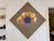 This large framed vintage artwork features a psychedelic, abstract swirling cloud-like formation resembling an eye, or a...