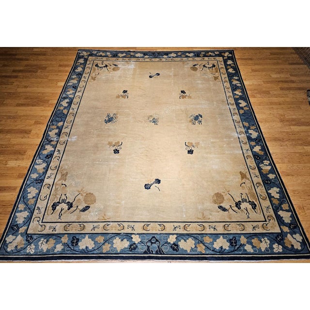 This 19th-century oversized Chinese Peking rug features a near-square format and a serene open-field design reminiscent of...