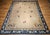 This 19th-century oversized Chinese Peking rug features a near-square format and a serene open-field design reminiscent of...