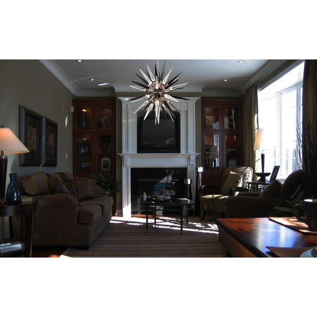 Italian Sputnik chandelier in a black and brass metal, 51 unobtainable trasparent and black glass tips. Murano blown glass...