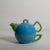 Adorable blue and green tea pot and cup set featuring a small star shape on the front of the tea pot.