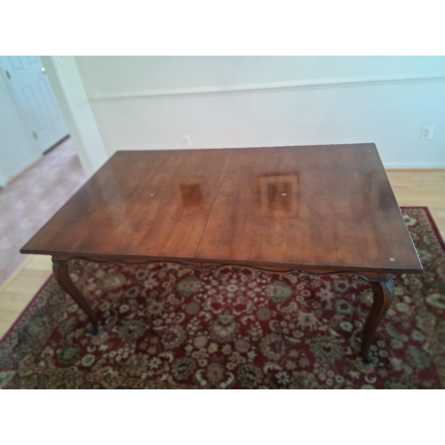 Introduce a centerpiece of enduring sophistication to your dining space with this exceptional vintage French Provincial-...