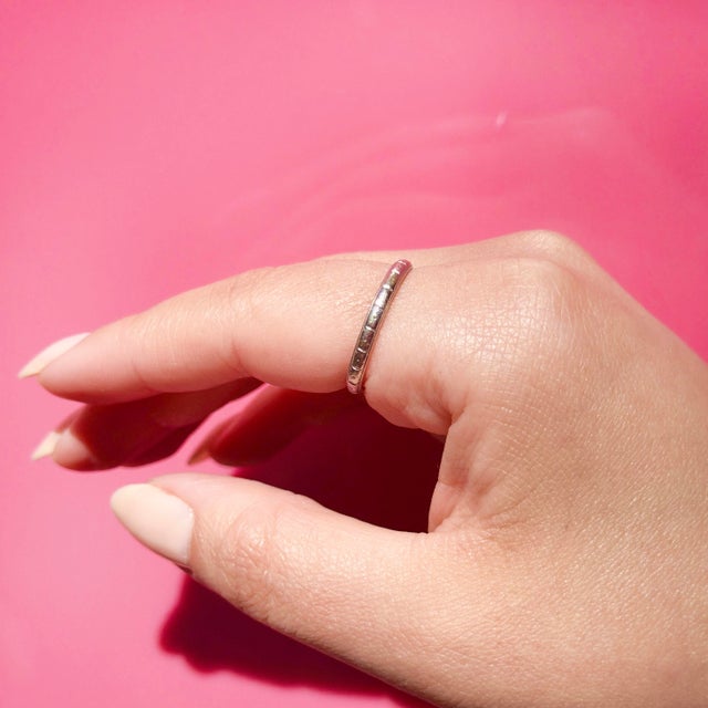 About This Ring: A timeless Art Deco wedding band carrying the intimate inscription "H.E. to D.P. 5-4-24," a beautiful...