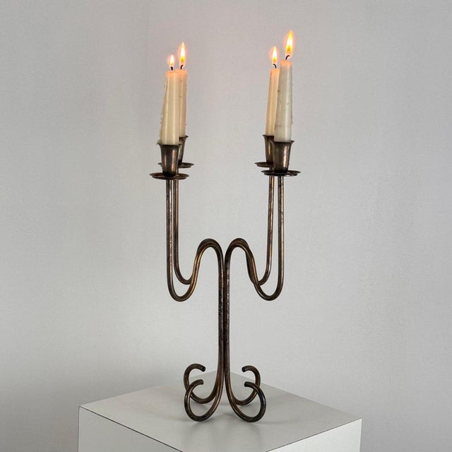 Introducing an elegant Italian four-arm candelabrum in silverplate from the 1930s. This exquisite piece features an...