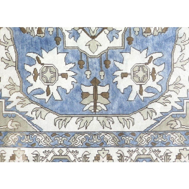 This vintage rug originates from Oushak in Western Turkey, where oriental rug weaving traditions were established on the...