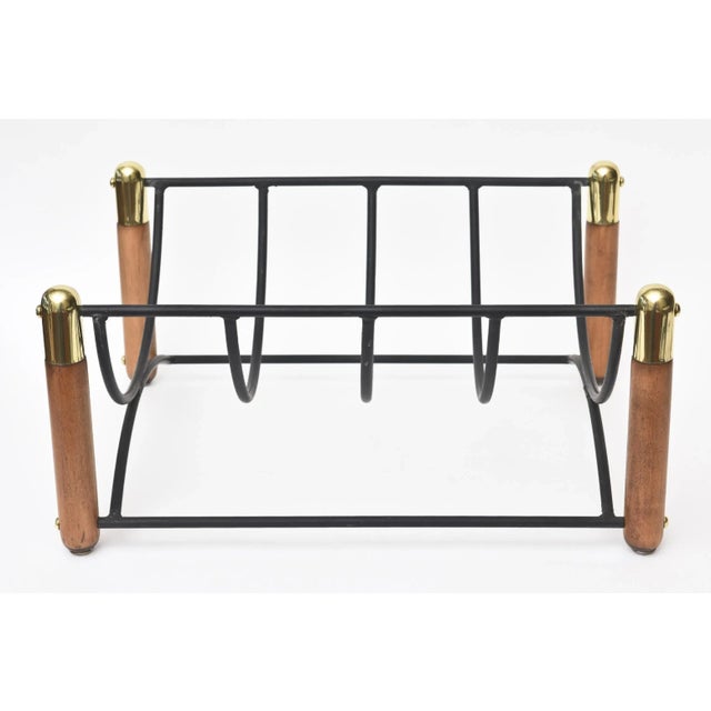 This midcentury modern brass, wood and black iron magazine rack and or log rack for a fireplace is handsome. The brass has...