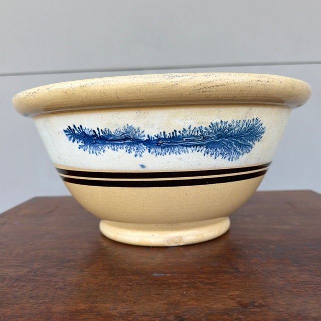Antique English Yellowware Mixing Bowl with Blue Seaweed Decoration, Circa 1840s A visually striking and decoratively...