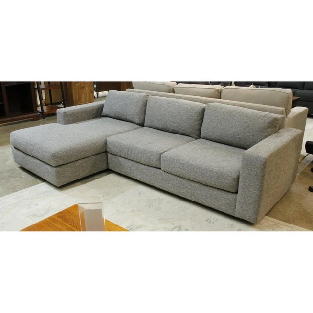 This contemporary sectional features a streamlined silhouette with wide track arms and a left-facing chaise for extended...