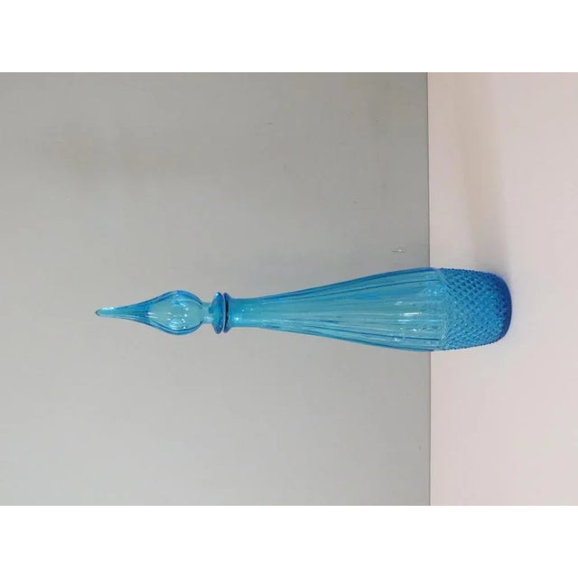 Blue Empoli bottle with stopper. Height: 43 cm Diameter bottom: 7 cm The bottle is labeled and in good condition.