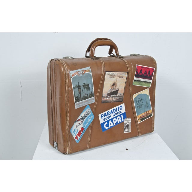 Vintage suitacse with old hotel, airline and cruise ship labels.