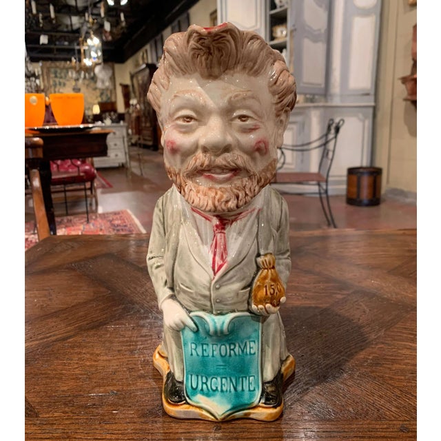 Whimsical and historically engaging, this antique barbotine pitcher portrays French politician and journalist Camille...