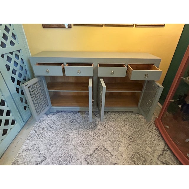 Sophisticated Asian style gray lacquer sideboard having 4 stunning hand carved lattice doors , 4 drawers and handsome...