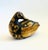 A vintage wood box in the shape of a duck. An intricately carved design of a village decorates the exterior of the box....