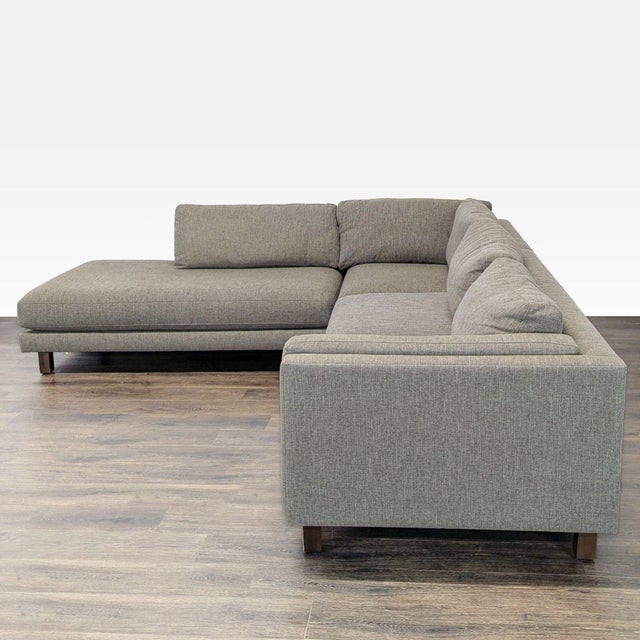 This Room & Board sectional features a modern design with clean lines and a spacious chaise lounge. Upholstered in a...