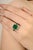 This statement ring features 6.53 Carat of vivid emerald cut emerald at the center, secured in a four prong 14k yellow...