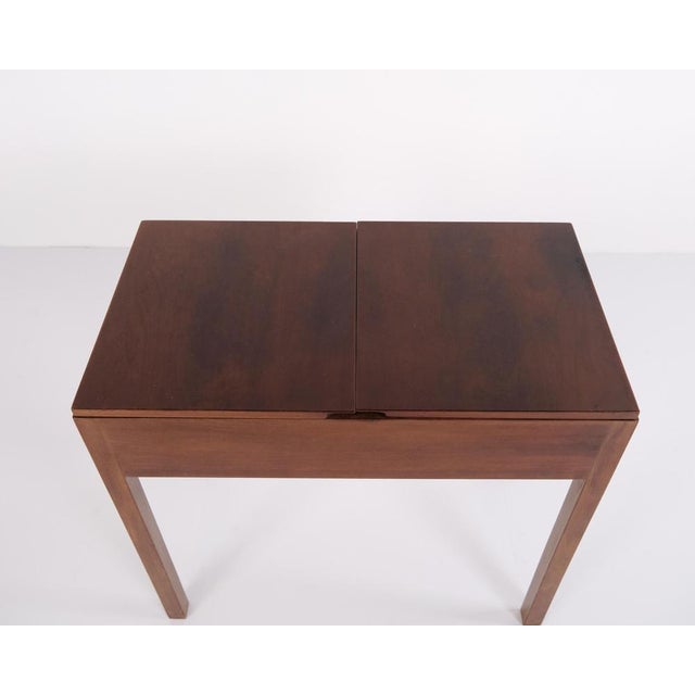 Mahogany sewing table dating from the 1940s. Designed with functionality in mind, the table features practical storage...