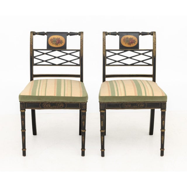 Pair of Regency Style Gilt and Ebonized Side Chairs, each with floral design painted to backrest, faux bamboo legs, and...
