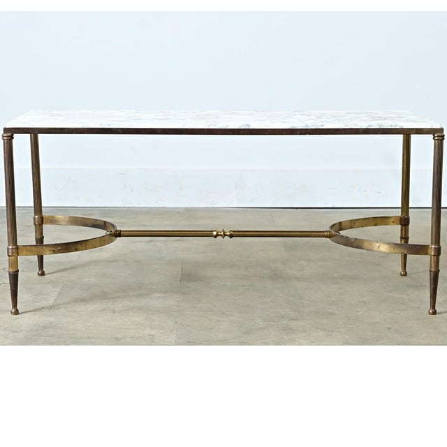 This vintage French coffee table is made from a single slab of Carrara marble with stunning light grey veining against a...