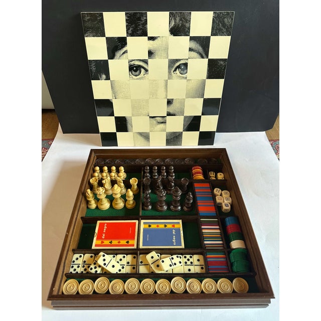 Vintage board game set box for Dal Negro by Piero Fornasetti, made in Italy in the 1970s. The box is made in walnut wood,...
