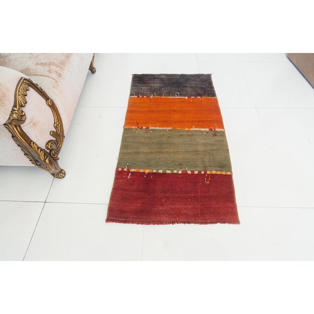 This is a vintage Turkish Oushak rug from the Mid 20th Century. The piece was hand-knotted.