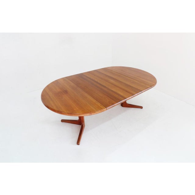 Vintage Danish round extendable dining table from the 1960s made of solid teak wood. This Danish dining table can be...