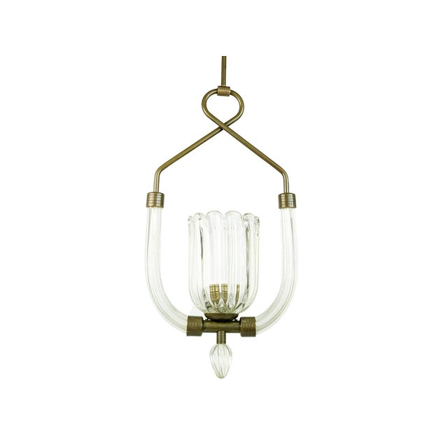 Elegant pendant lamp produced between the late 1930s and 1940s in clear Murano glass and brass. Unlike similar products of...
