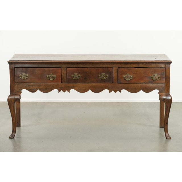 We are pleased to offer this beautiful antique English sideboard from the 18th century, crafted from oak with elegant...