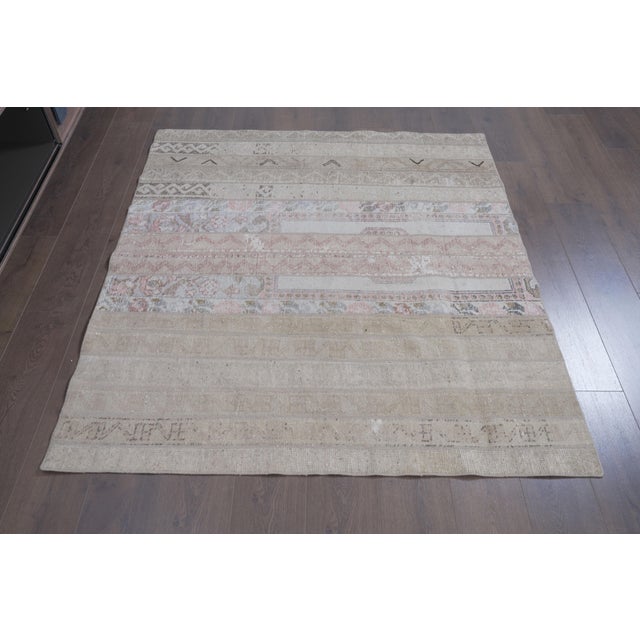 Transform your interior with this serene and sophisticated vintage Anatolian patchwork area rug. Thoughtfully crafted by...
