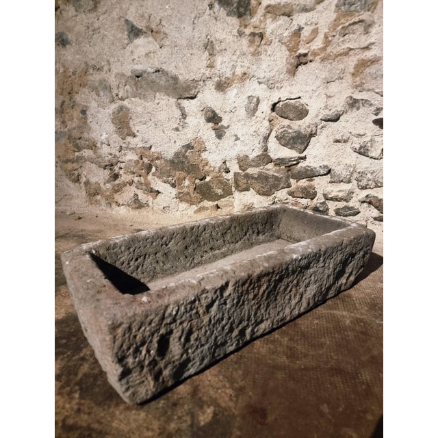 This antique stone trough originates from the Puy-de-Dôme region in central France and dates from approximately 1750 to...