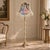 Bring an unmistakable sense of European elegance to your interior with this ornate French-style floor lamp, featuring a...