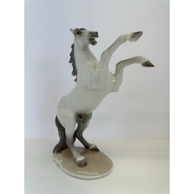 Majestic Vintage Nymphenburg Hand-Painted Porcelain Rearing Stallion Figurine Signed by August Göhring This exquisite...