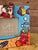 Whimsical hand-painted coastal picture frame featuring a playful mermaid surrounded by tropical fish, crabs, seashells,...